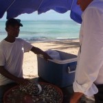 chef on beach looking at clams las terrenas dominican republic caribbean