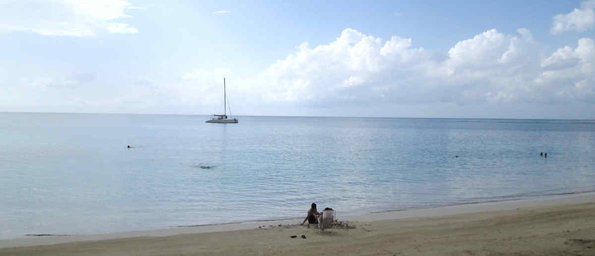 Blue water and catamaran pictured Las Terrenas, Punta Popy